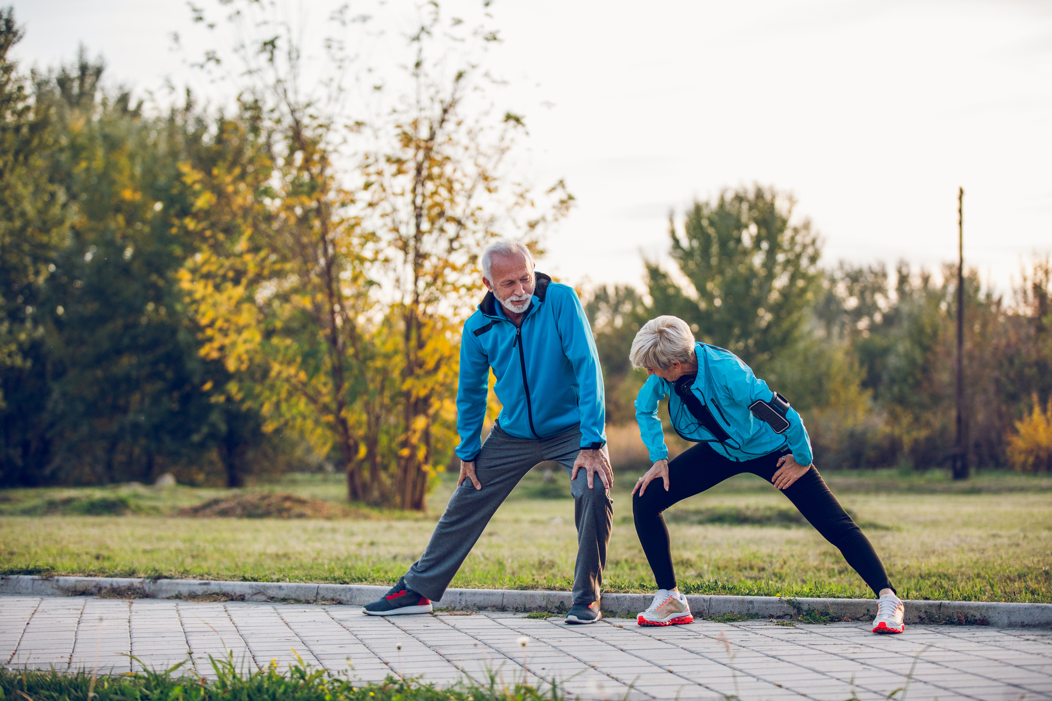 A senior couple stretching outside